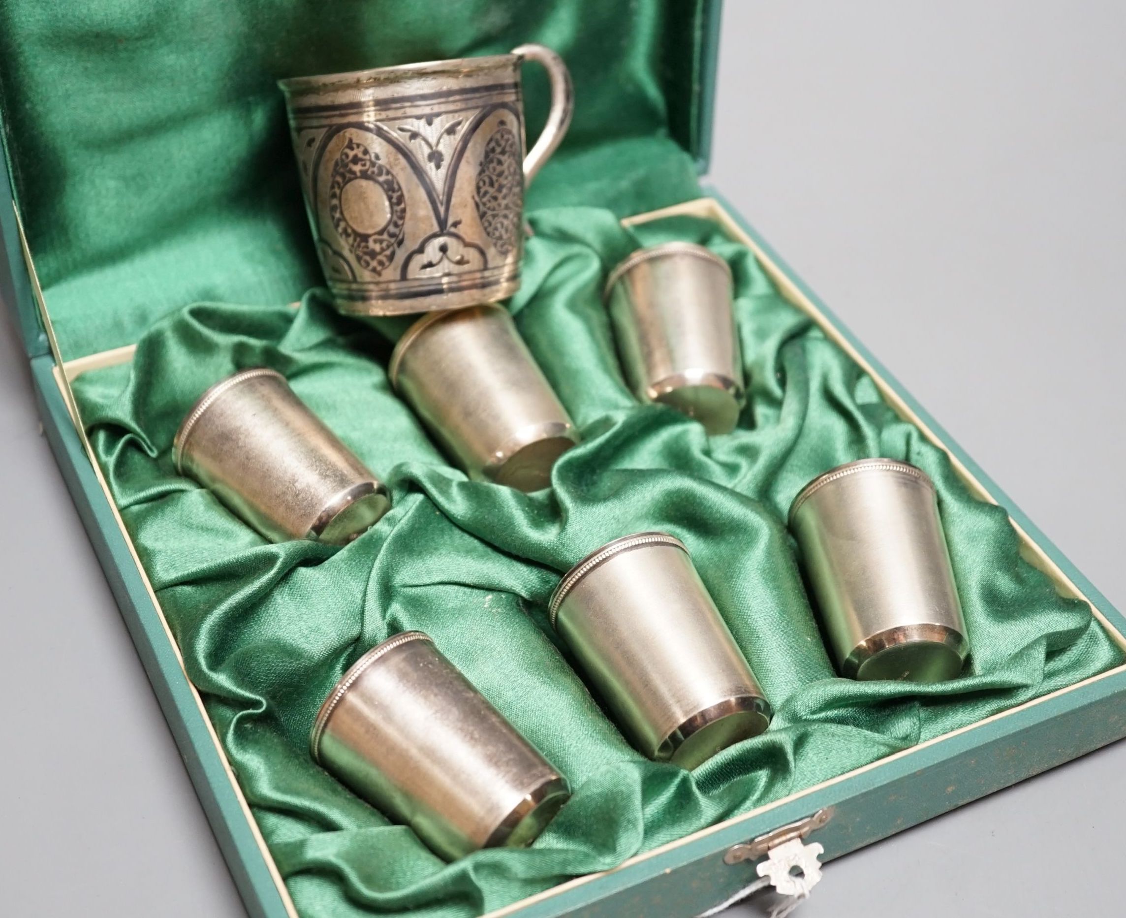 A cased set of six mid 20th century Soviet Union white metal tots, 5cm and an earlier 875 zolotnik and niello mug.